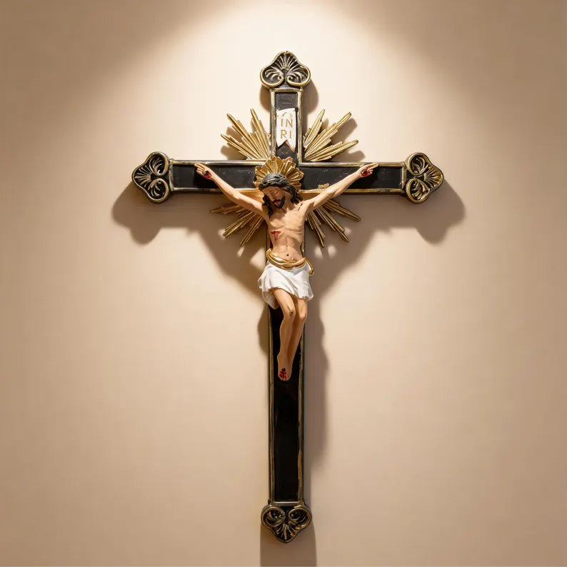 1-ornate black and gold wall crucifix statue under holy light