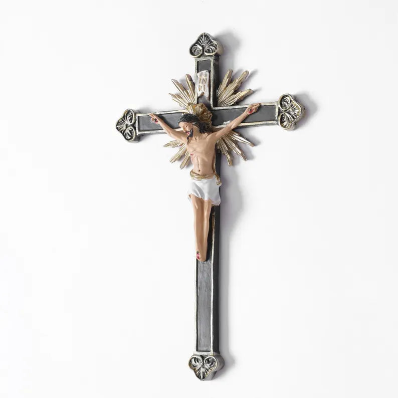 ornate black and gold wall crucifix statue white background with shadow