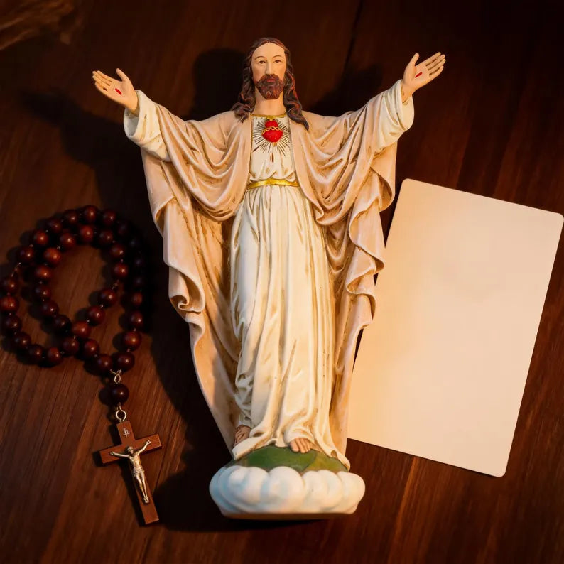 3-handmade sacred heart of jesus statue on wooden table with rosary