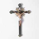 ornate black and gold wall crucifix statue plain background