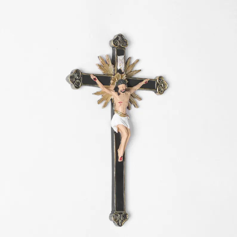 ornate black and gold wall crucifix statue plain background